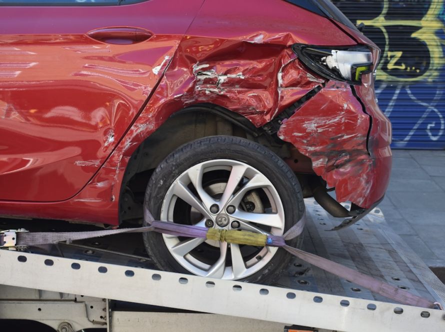 Car being towed after collision - vehicle safety varies dramatically between models based on IIHS crash test ratings