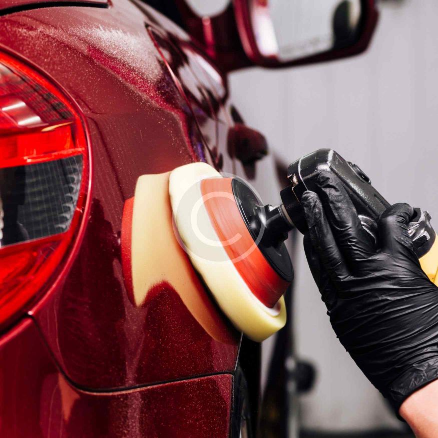 Collision repair technician working on vehicle