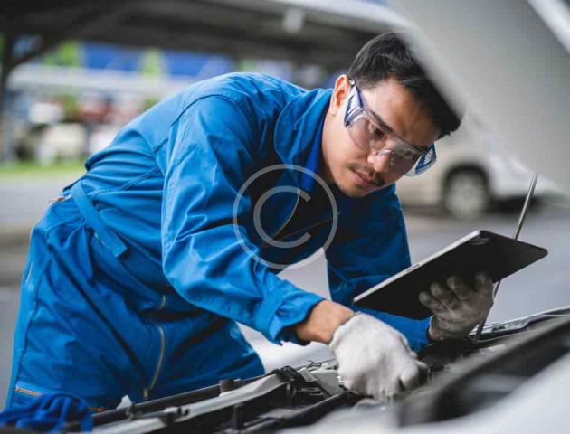 Auto body technician performing repairs